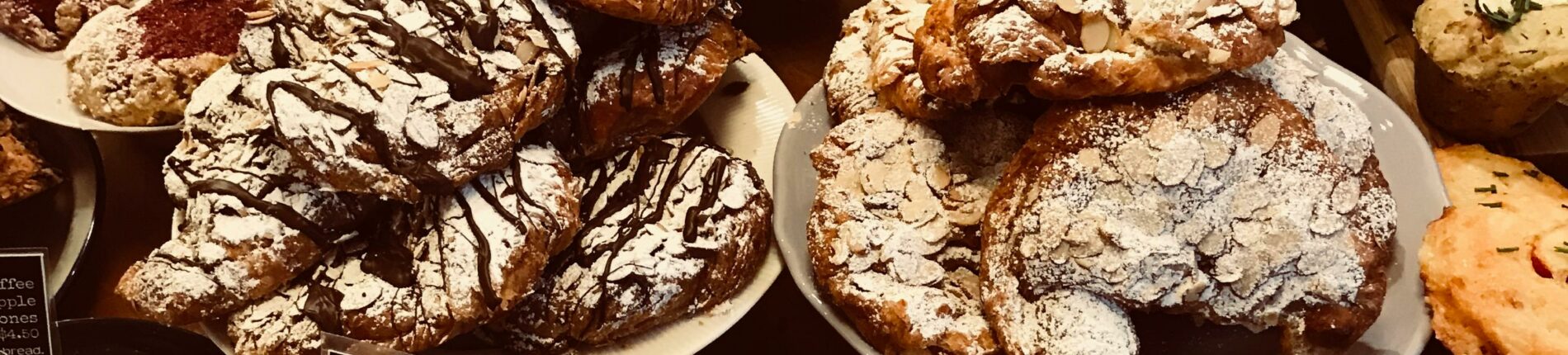 A mouthwatering selection of diverse pastries in a cozy bakery setting.