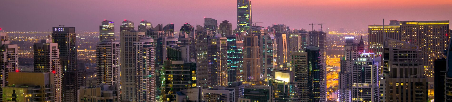 Captivating view of Dubai's skyline at dusk with vibrant city lights and skyscrapers.