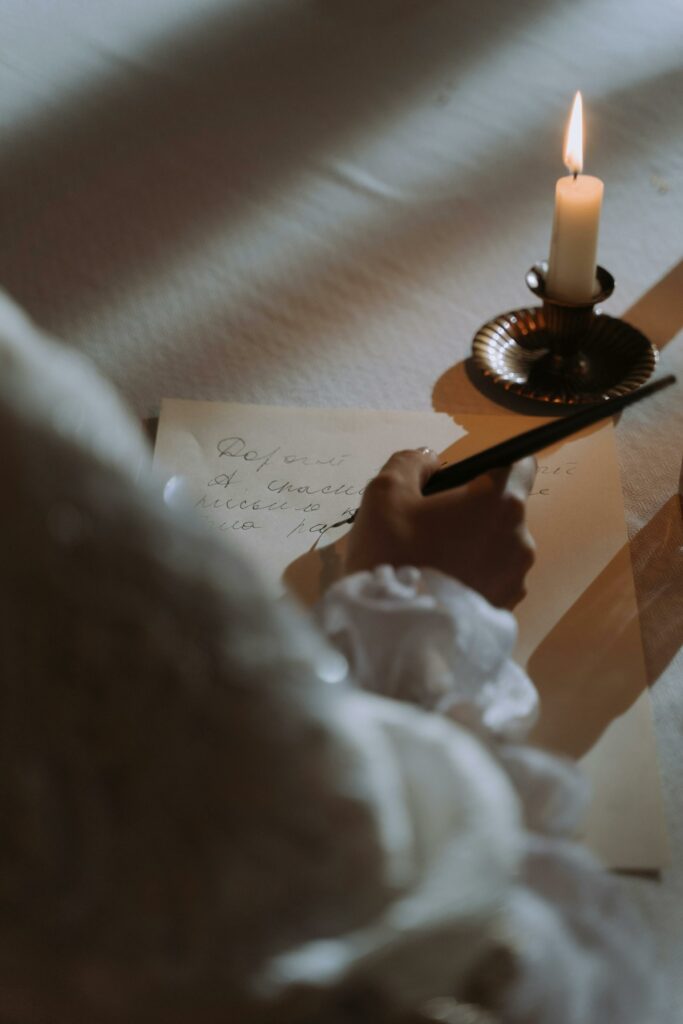 Elegant handwriting illuminated by a candle for a vintage, cozy ambiance.